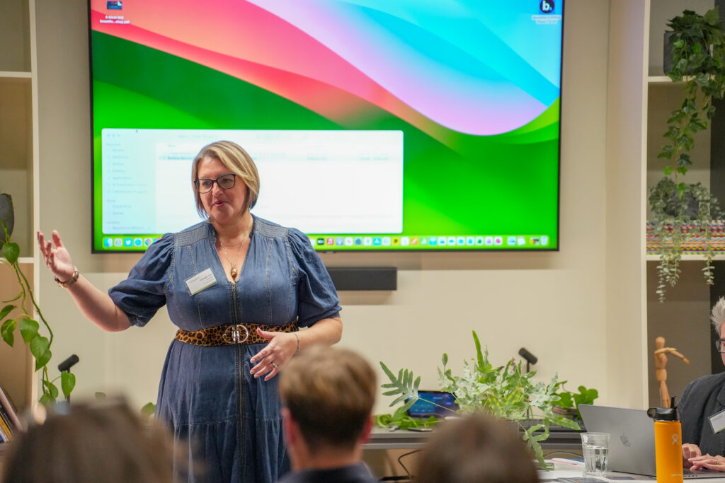 Woman facing and speaking to an audience