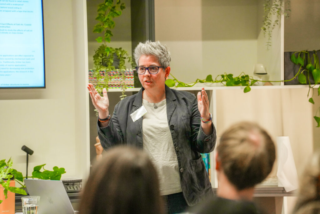 Women with short hair facing an audience.