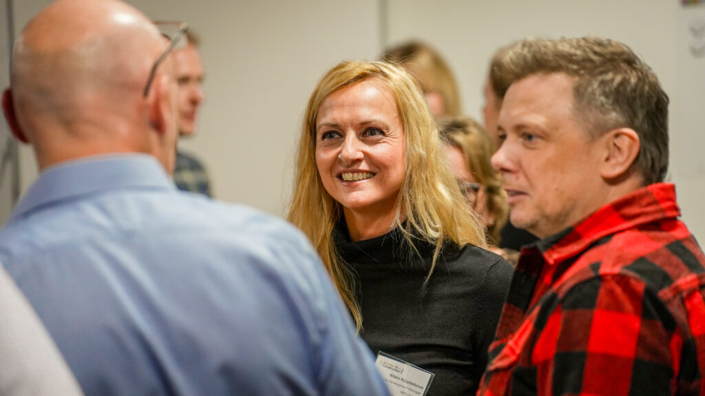 A group of people talking at a corporate event
