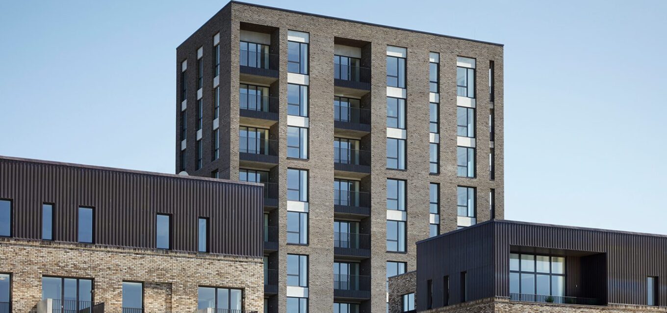 Residential brick building with a lot of windows and balconies.