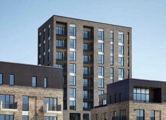 Residential brick building with a lot of windows and balconies.
