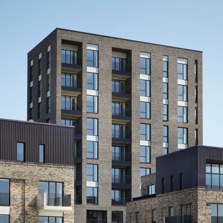 Residential brick building with a lot of windows and balconies.