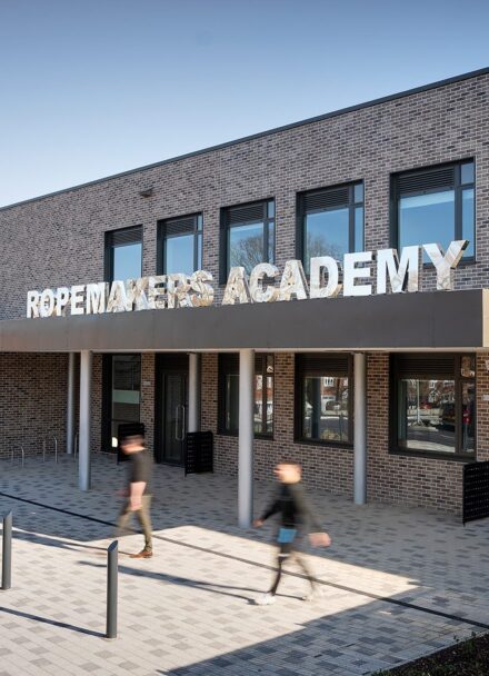 Secondary school entrance to brick clad school with large letters spelling Ropemakers Academy.
