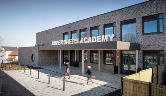 Secondary school entrance to brick clad school with large letters spelling Ropemakers Academy.