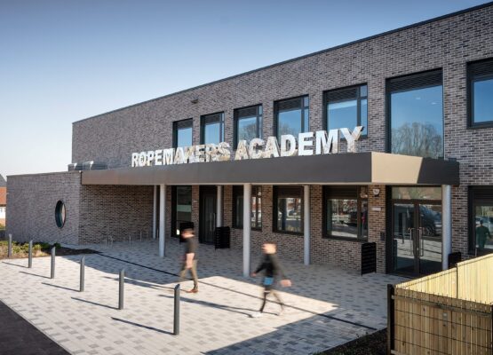 Secondary school entrance to brick clad school with large letters spelling Ropemakers Academy.
