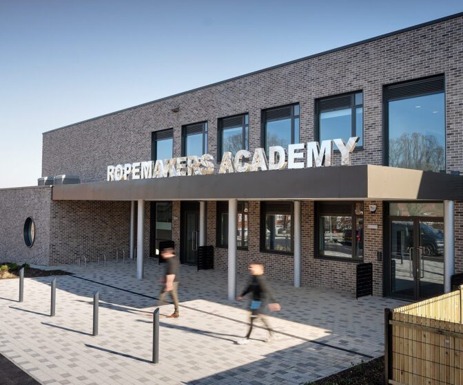 Secondary school entrance to brick clad school with large letters spelling Ropemakers Academy.
