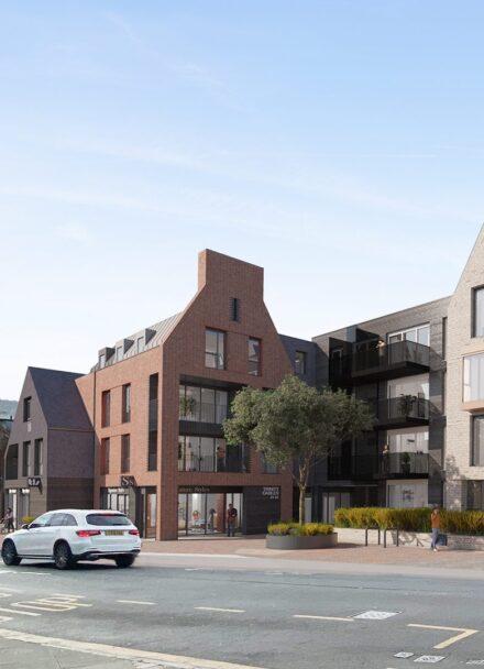 CGI of residential development in a contemporary style with gables in a mix of red and grey brick and darker cladding.