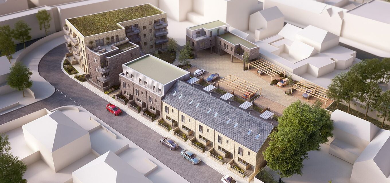 Aerial view of a residential housing development in a contemporary architectural style with a mix of flats and houses