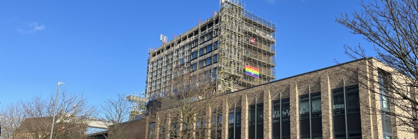 Educational retrofit building with scaffolding up during the recladding of the tower