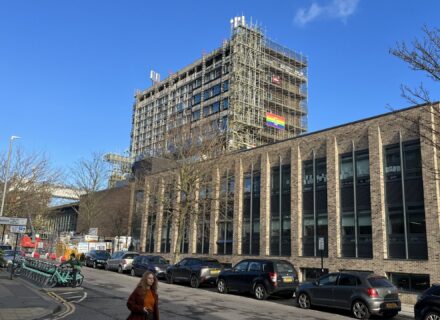 Educational retrofit building with scaffolding up during the recladding of the tower