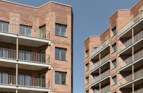 Two high rise residential buildings opposite each other, with a slither of blue sky appearing between them
