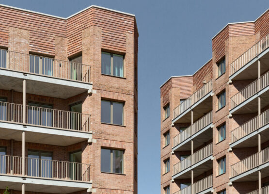 Two high rise residential buildings opposite each other, with a slither of blue sky appearing between them
