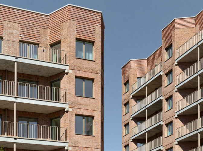 Two high rise residential buildings opposite each other, with a slither of blue sky appearing between them