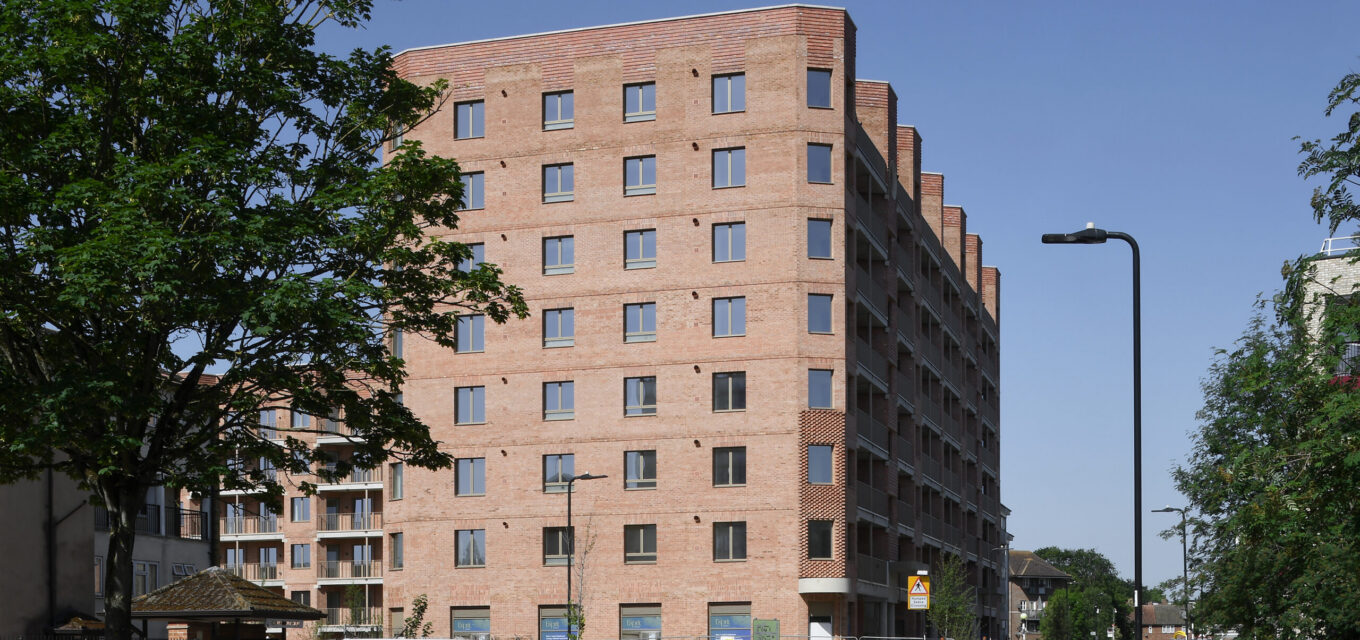 Residential social housing block with cars parked in front of it